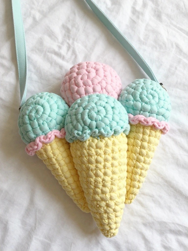 Crocheted bag of three yellow ice cream cones with pink and mint scoops