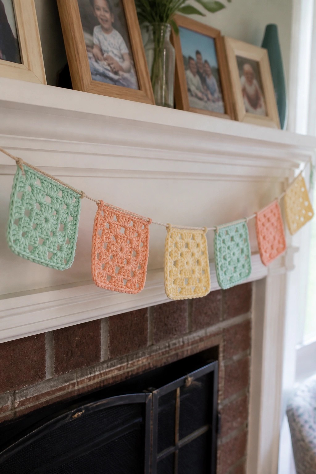 Pastel crocheted granny square bunting draped on white brick fireplace mantel